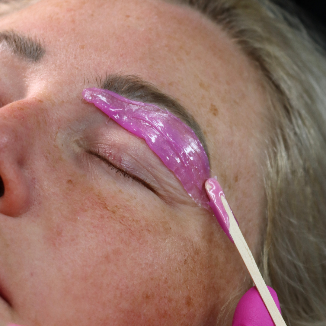 Siren hard wax being applied to the eyebrow. 