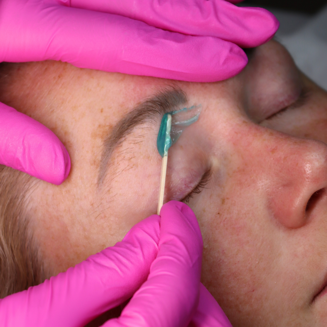 Pinkfishes Lagoon Strip Wax being used for eyebrow hair removal.