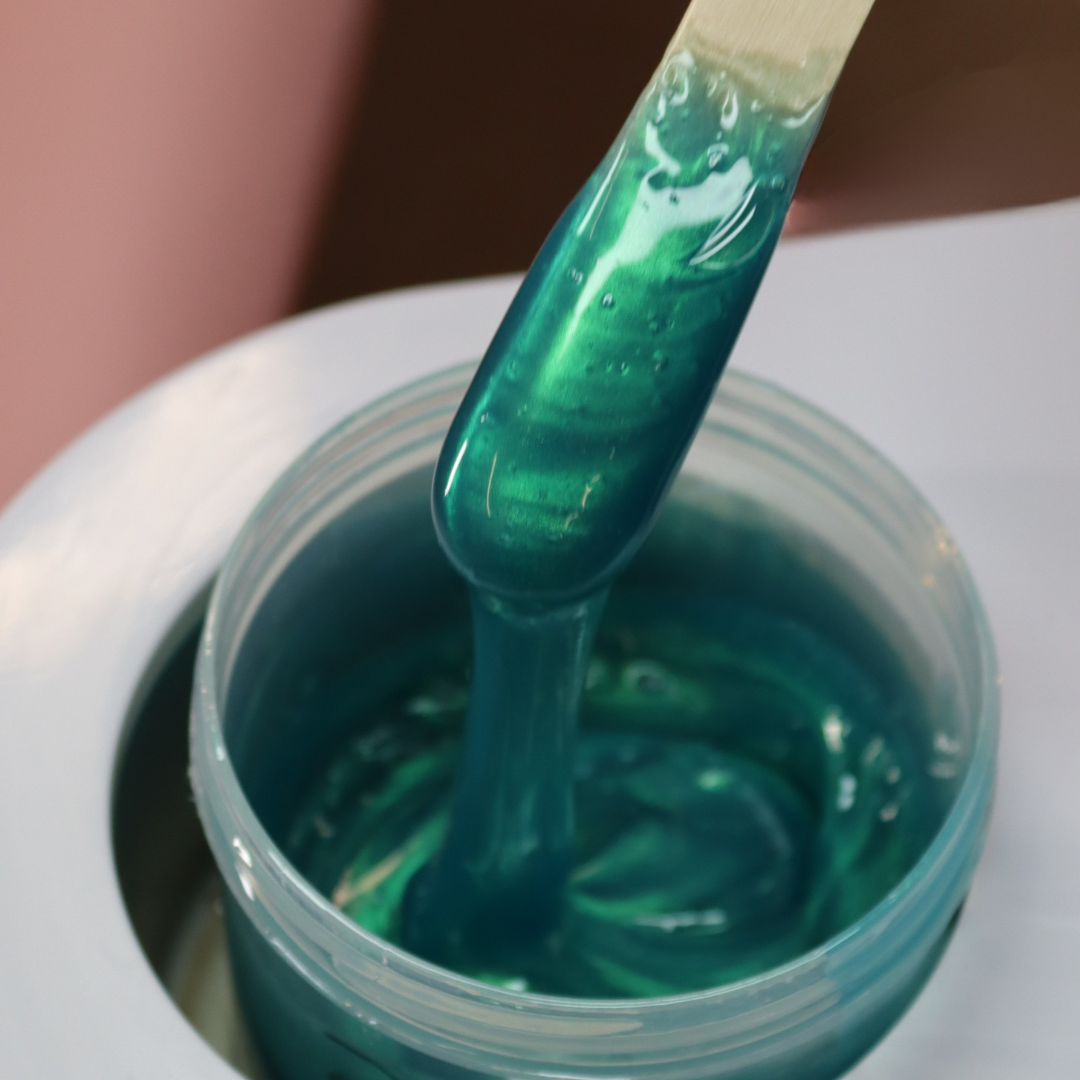 Lagoon wax dripping off waxing spatula. 