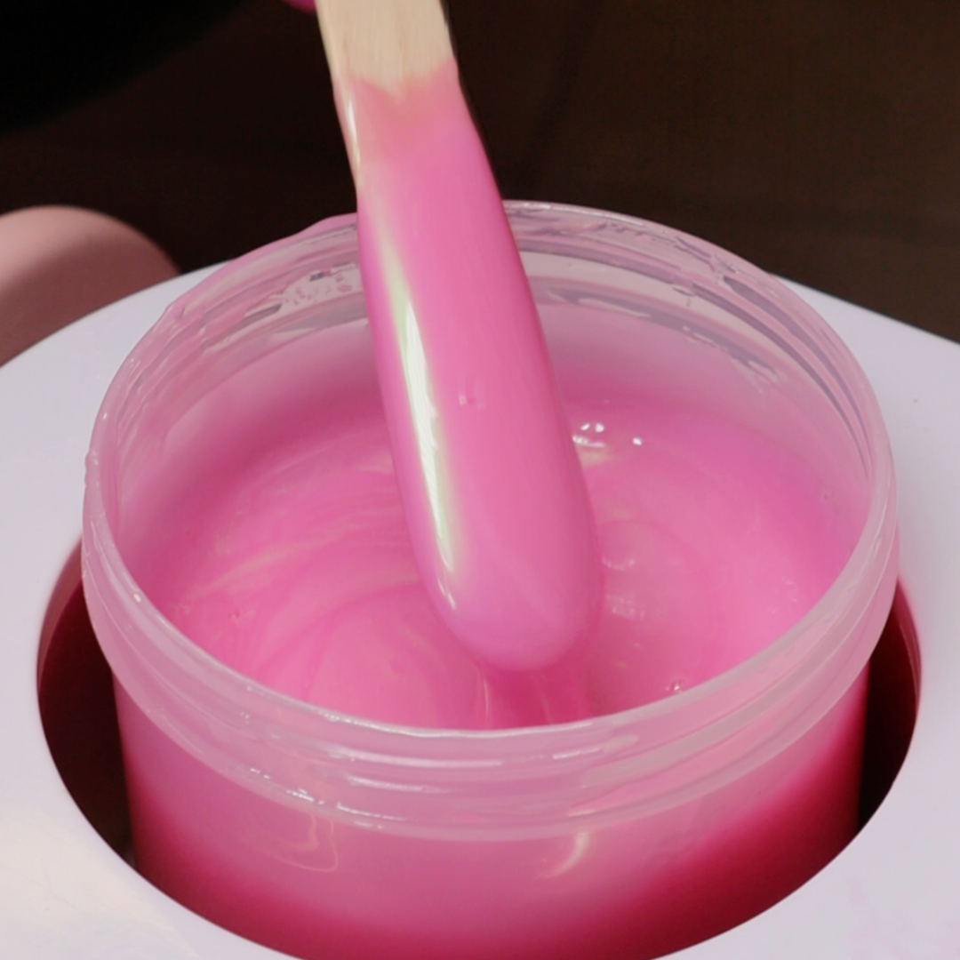 Close up of Shell Soft Wax dripping off a waxing spatula.