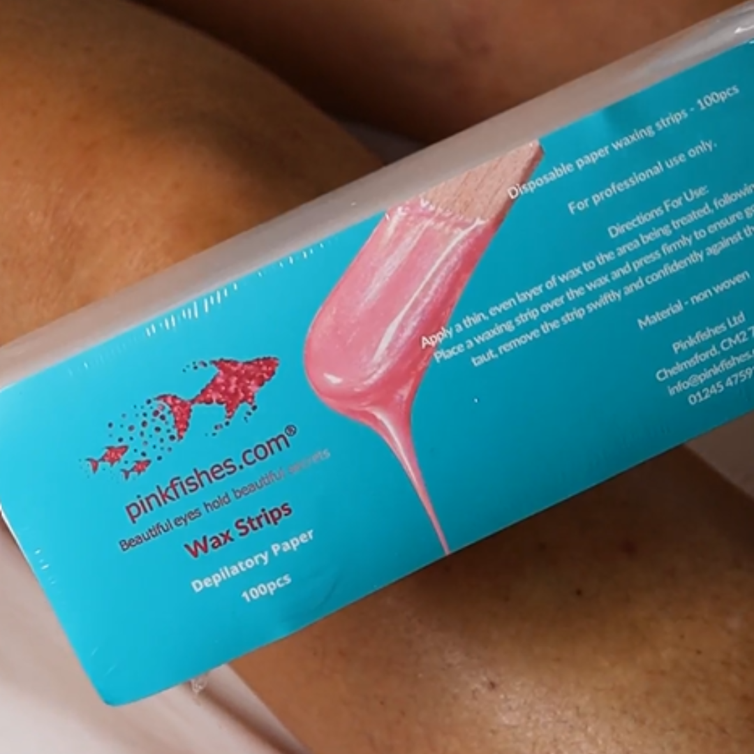 A close-up of a pinkfishes.com Wax Strips box, showing the blue packaging with a graphic of pink wax and product details.